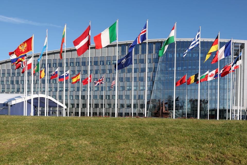 Flags of member nations flap in the wind outside NATO headquarters during a meeting of NATO foreign ministers in Brussels, Tuesday, April 4, 2023.