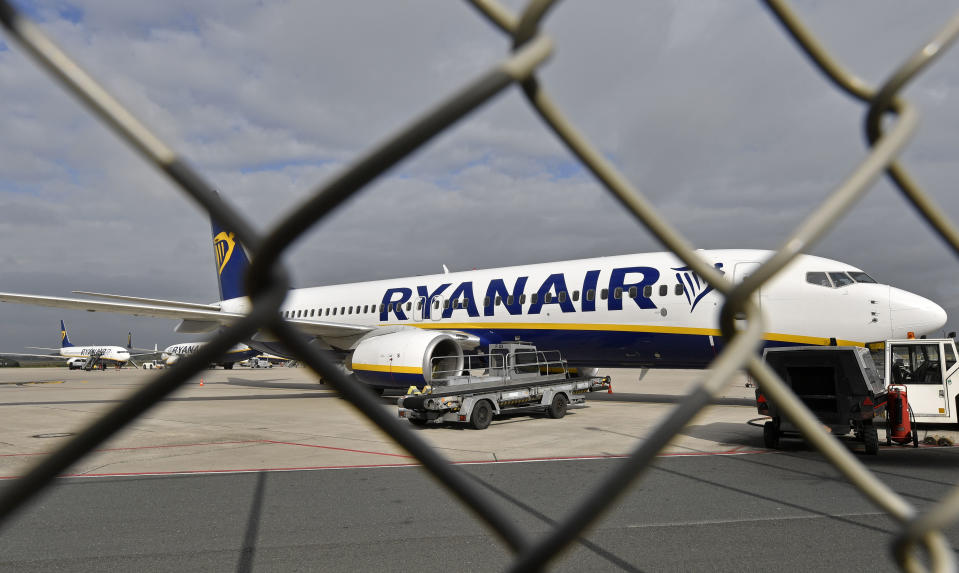 FILE - In this Wednesday, Sept. 12, 2018 file photo, a Ryanair plane is parked at the airport in Weeze, Germany. Europe's biggest airline by passengers, budget carrier Ryanair, will cut flights and close some of its bases beginning this winter because of the delay to deliveries of the Boeing 737 Max plane, which has been grounded globally after two fatal crashes. The airline warned Tuesday, July 16, 2019, its growth in European summer traffic for 2020 will be lower than expected because of the slowed deliveries. (AP Photo/Martin Meissner, File)