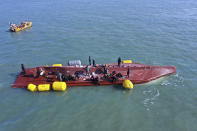 Members of the rescue team search for people from a capsized boat in waters off the country's southwestern coast, South Korea, Sunday, Feb. 5, 2023. South Korean coast guard vessels and aircraft were searching on Sunday in waters off the country's southwestern coast for nine fishermen who disappeared after their boat capsized. (Jung Hee-sung/Yonhap via AP)