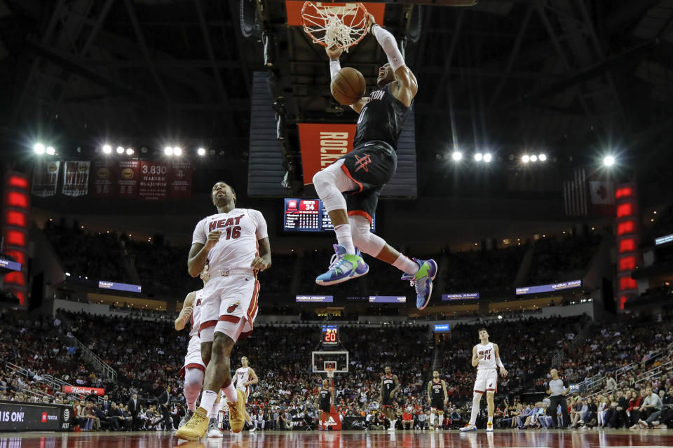 HOUSTON, TX - NOVEMBER 27:  Russell Westbrook #0 of the Houston Rockets dunks the ball in front of James Johnson #16 of the Miami Heat in the first half at Toyota Center on November 27, 2019 in Houston, Texas.  NOTE TO USER: User expressly acknowledges and agrees that, by downloading and or using this photograph, User is consenting to the terms and conditions of the Getty Images License Agreement.  (Photo by Tim Warner/Getty Images)