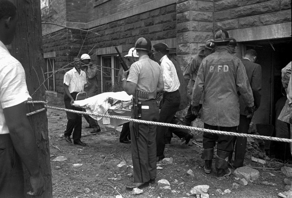 Firemen and ambulance attendants remove a covered body from Sixteenth Street Baptist Church, where an explosion ripped the structure during services, killing four Black girls, in this Sept.15, 1963.  Church members will remember the girls' deaths on the 40th anniversary of the bombing, with a three-day commemoration that begins with worship Sunday, Sept. 14, 2003, according to the Rev. Arthur Price Jr. A memorial service will be held Monday night, and a revival service looking forward is set for Tuesday.
