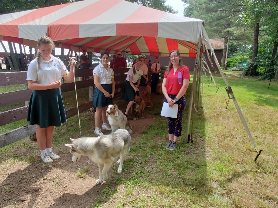 Holly Lewis, an alumni of the 4-H dog show, now judges and helps guide younger kids working with their dogs during the Stratham 4-H Summerfest at Stratham Hill Park Saturday, July 16, 2022.