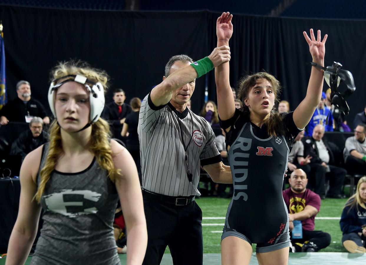 Angelina Pena of Milan puts up four fingers as she won her fourth state championship over Isabella Cepak of South Lyon East with a pin in second period at the MHSAA State Individual Wrestling Championships at Ford Field in Detroit on Saturday, March 2, 2024.