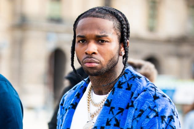 Rapper Pop Smoke, wearing a blue Off-White coat, is seen outside the Off-White show during the Paris Fashion Week - Menswear F/W 2020-2021 on January 15, 2020 in Paris, France.  - Credit: Claudio Lavenia/Getty Images