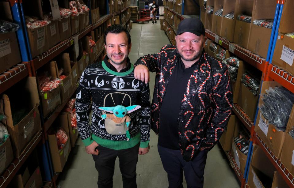 Fred and Mark Hajjar, co-founders of UglyChristmasSweater.com inside their 42,000 square foot warehouse in Commerce Township, Mich., on Oct. 12, 2021. Their online retail store has a large supply of Christmas sweaters and other items stuck on freighters off the coast of California.