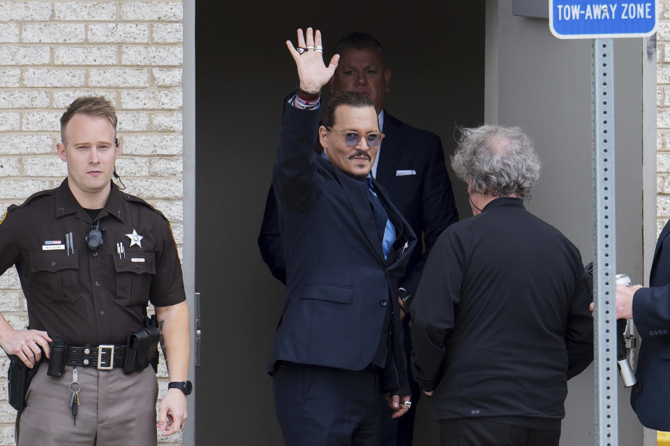 Actor Johnny Depp waves to supporters outside of Fairfax County Courthouse in Fairfax, Va., on Friday, May 27, 2022. A jury is scheduled to hear closing arguments in Depp's high-profile libel lawsuit against ex-wife Amber Heard.(AP Photo/Craig Hudson)