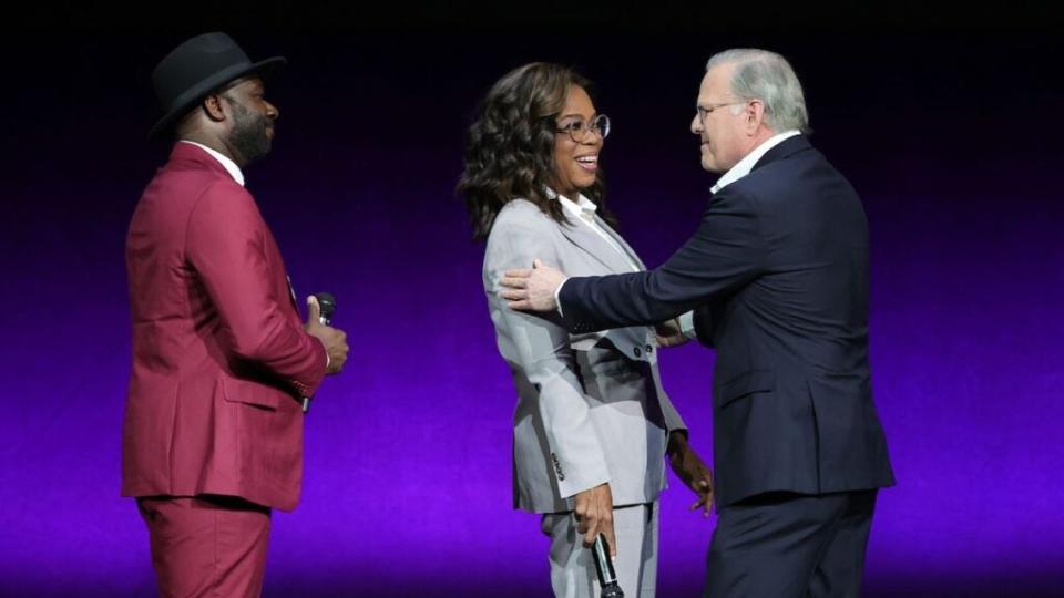 Blitz Bazawule and Oprah Winfrey are welcomed onstage by Warner Bros. Discovery CEO David Zaslav as they promote the upcoming film “The Color Purple” during the Warner Bros. Pictures Studio presentation during CinemaCon. (Ethan Miller/Getty Images)