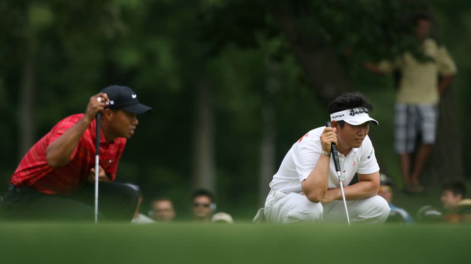 Woods and Yang eye up their putts during the final round. - Charles Baus/Icon SMI/Getty Images