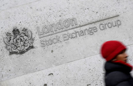 A woman walks past the London Stock Exchange building in the City of London, Britain, January 16 , 2017. REUTERS/Toby Melville/File Photo