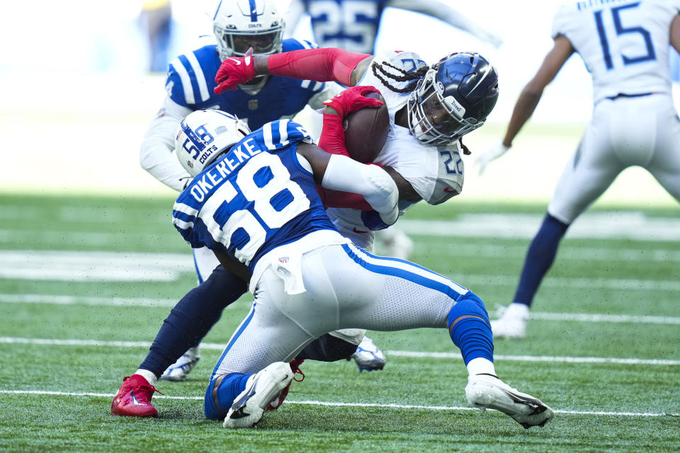 Tennessee Titans running back Derrick Henry is tackled by Indianapolis Colts linebacker Bobby Okereke in the second half of an NFL football game in Indianapolis, Fla., Sunday, Oct. 2, 2022. (AP Photo/AJ Mast)