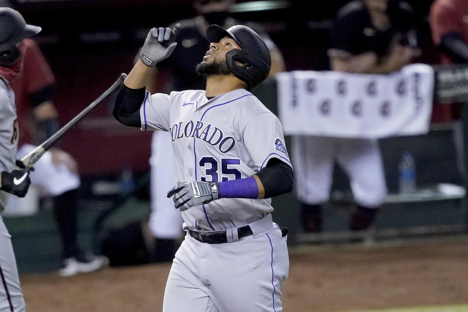 Colorado Rockies' Elias Diaz (35) points upward after hitting a two run home run against the Arizona Diamondbacks during the fourth inning of a baseball game, Saturday, Sept. 26, 2020, in Phoenix. (AP Photo/Matt York)