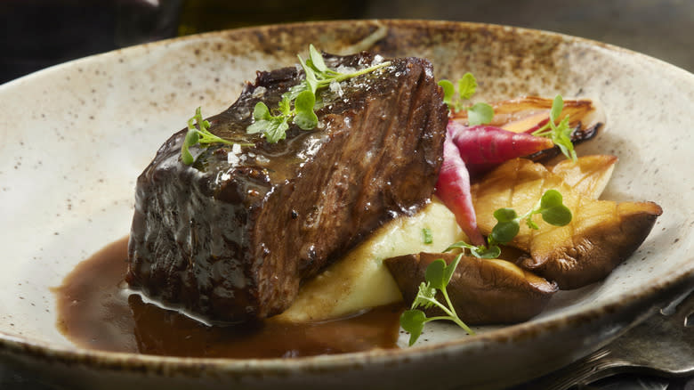 Cooked short rib plated with vegetables