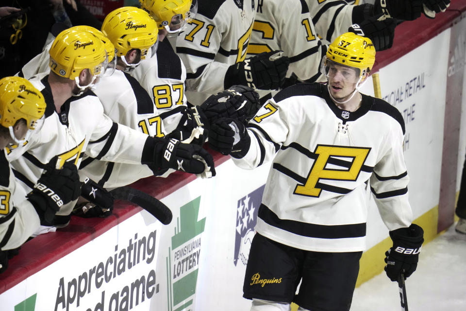 Pittsburgh Penguins' Rickard Rakell (67) returns to the bench after scoring during the first period of an NHL hockey game against the Philadelphia Flyers in Pittsburgh, Saturday, March 11, 2023. (AP Photo/Gene J. Puskar)