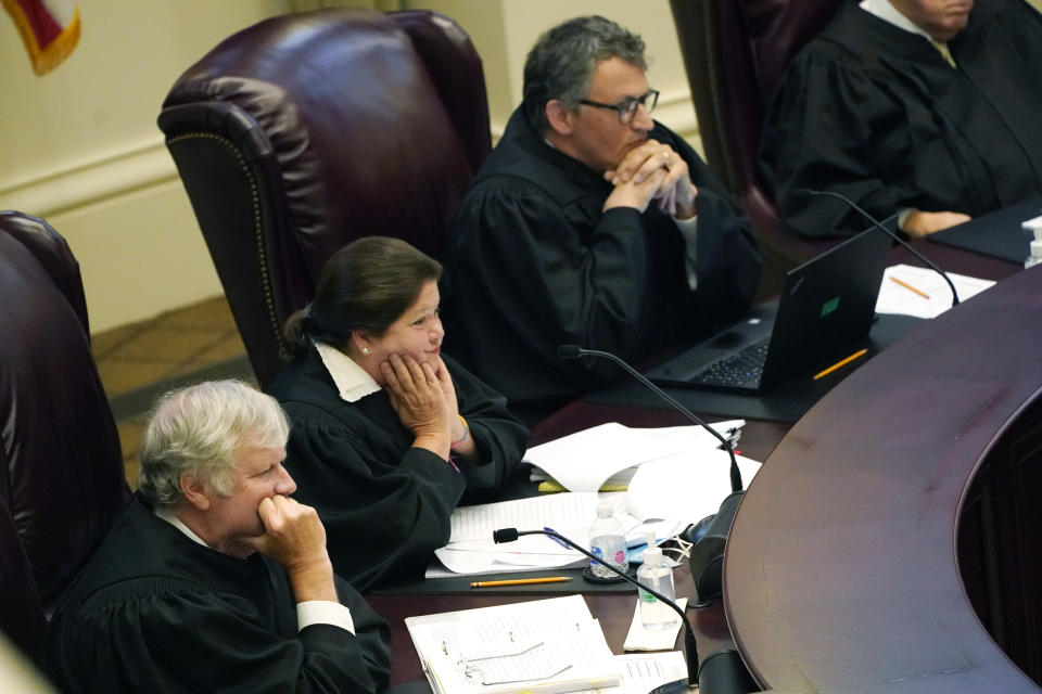 Mississippi Supreme Court Associate Justices T. Kenneth Griffis, left, Dawn Beam, center and Josiah Dennis Coleman, listen to attorneys presenting arguments over a lawsuit that challenges the state's initiative process and seeks to overturn a medical marijuana initiative that voters approved in November 2020, Wednesday, April 14, 2021, in Jackson, Miss. (AP Photo/Rogelio V. Solis)