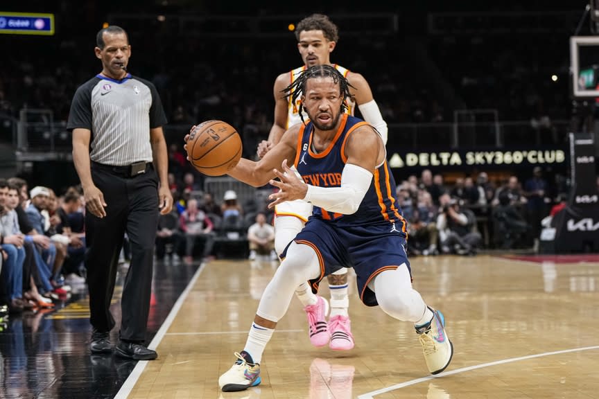 New York Knicks guard Jalen Brunson (11) keeps the ball in bounds behind Atlanta Hawks guard Trae Young (11) during the first half at State Farm Arena.