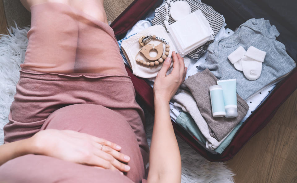 A pregnant woman and a hospital bag.