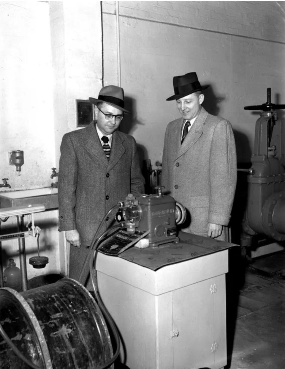 This simple apparatus was at the heart of the city's new fluoridation program more than seven decades ago. Checking its operation in March 1952 are A.E. Ransom, left, then water superintendent, and Dr. H.W. McConnell, then president of the Canton Dental Society.