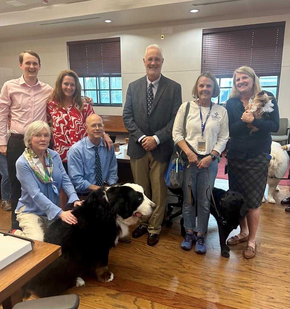 The Florida Bar Animal Law Section awarded Circuit Judge Jonathan Sjostrom with the 2023 Judicial Achievement Award on July 17, 2023, for his support of the 2nd Judicial Circuit's Animal Therapy Dog Program. Pictured left to right at the top are Noah Sjostrom, Erin Sjostrom, Chief Judge Frank Allman, Allison Hankinson with her dog Sadie and Circuit Judge Angela Dempsey with animal therapy dog Jazz, and in the bottom row, Dawn Talley and Judge Sjostrom, with his dog Mike.