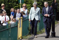 Britain's Prime Minister Theresa May and her husband Philip arrive at a polling station to vote in the European Elections in Sonning, England, Thursday, May 23, 2019.(AP Photo/Frank Augstein)