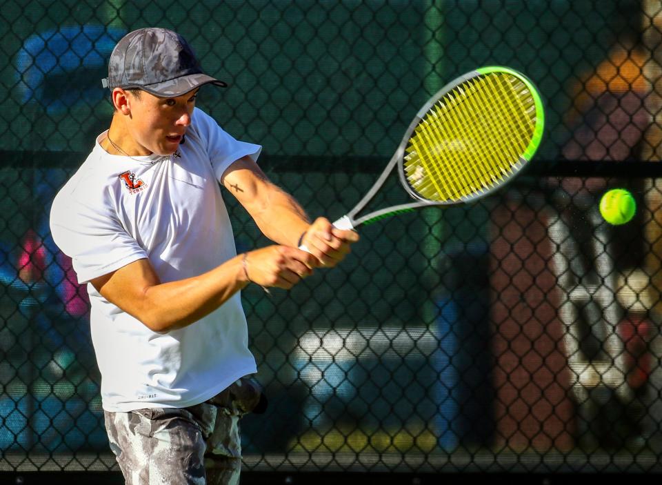 Lakeland's Sam Reeder hits a backhand shot during his No. 1 doubles match against St. Petersburg on Monday in the Class 3A boys tennis state tournament at Sanlando Park in Altamonte Springs.