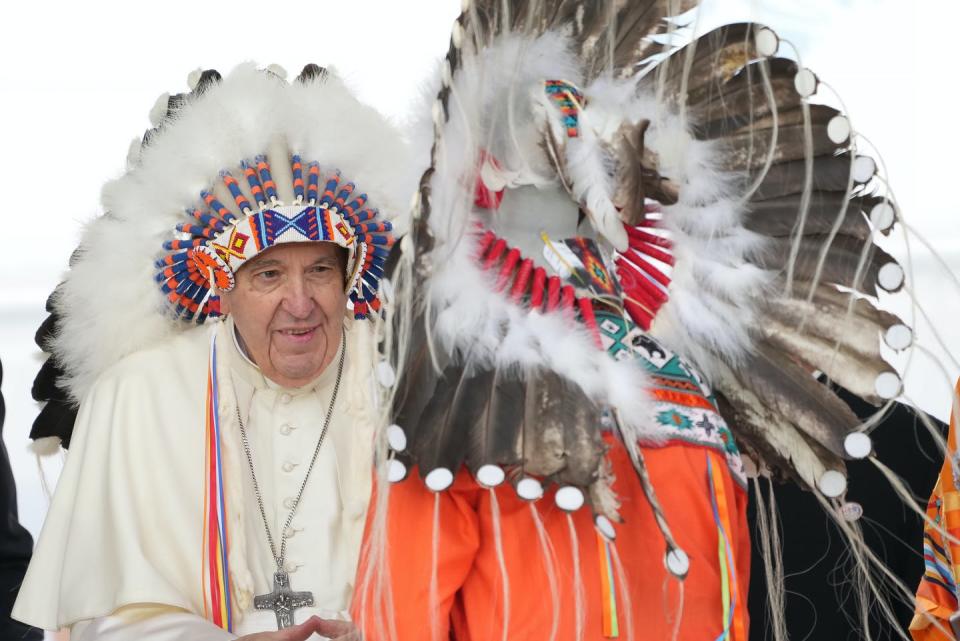 Pope Francis wears a headdress he was given after his apology to Indigenous people during a ceremony in Maskwacis, Alta. on July 25, 2022. THE CANADIAN PRESS/Nathan Denette