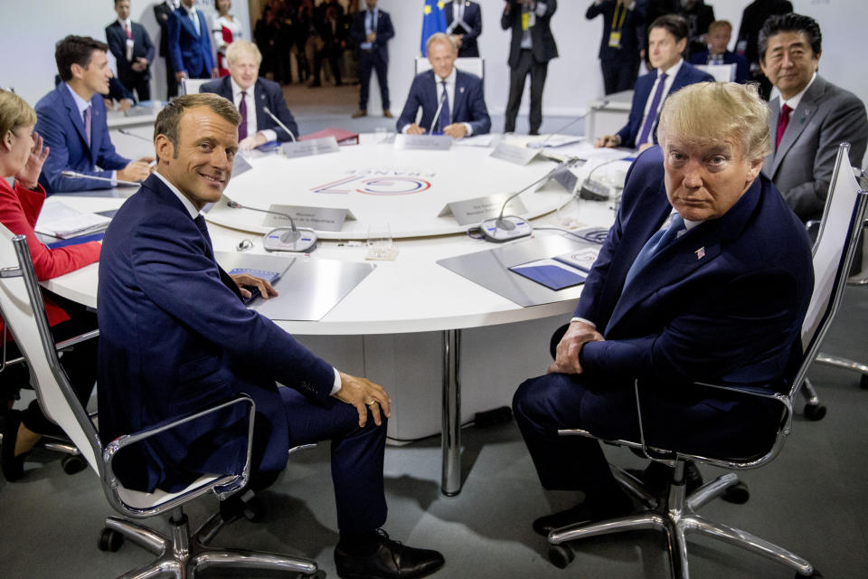 FILE - French President Emmanuel Macron, center left, and U.S. President Donald Trump, center right, participate in a G-7 Working Session on the Global Economy, Foreign Policy, and Security Affairs the G-7 summit in Biarritz, France, Sunday, Aug. 25, 2019. As Trump becomes the first former president to face federal charges that could put him in jail, many Europeans are watching the case closely. But hardly a single world leader has said a word recently about the man leading the race for the Republican party nomination.. (AP Photo/Andrew Harnik, Pool, File)