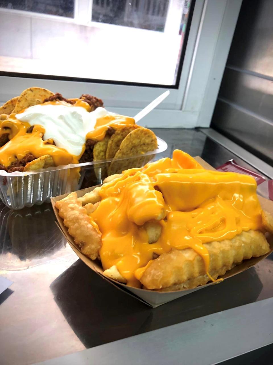 Fat crinkle fries and nachos with taco meat and sour cream on the JT's American Food on the Fly truck.