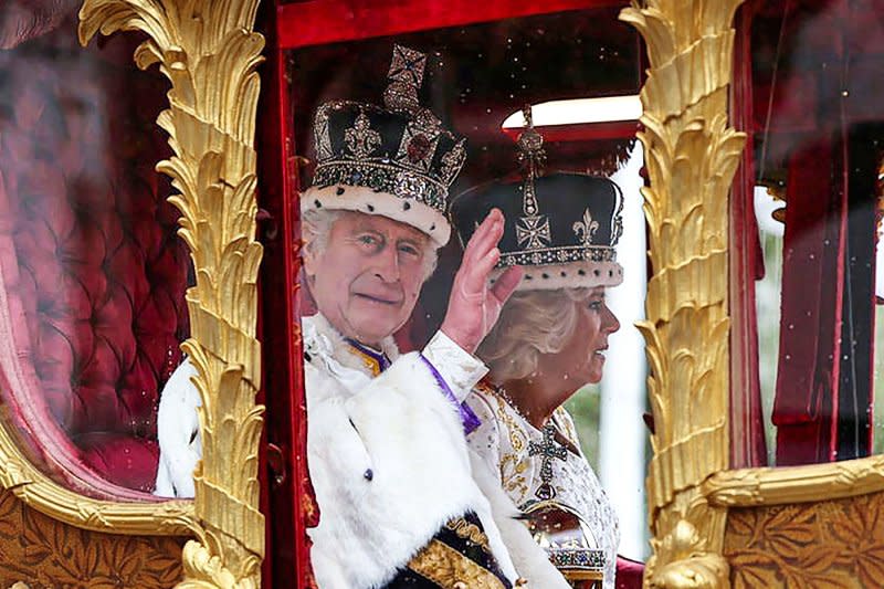 King Charles III and his wife Queen Camilla travel in the Gold State Carriage back to Buckingham Palace after Charles's coronation in London on May 6. In his Christmas address on Monday, the king urged protection of both people and the environment. File Photo by British Ministry of Defense/UPI