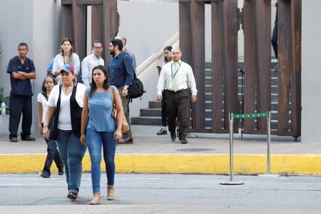 People evacuate an office building after an earthquake in Caracas, Venezuela August 21, 2018. REUTERS/Marco Bello