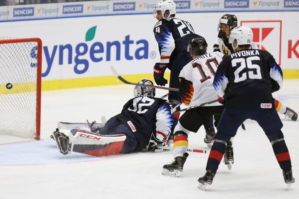 From left, USA goalkeeper Dustin Wolf, Mattias Samuelsson, Germany's Justin Schuetz and Jacob Pivonka of the USA in action during the 2020 IIHF World Junior Ice Hockey Championships Group B match between Germany and USA in Ostrava, Czech Republic, Friday Dec. 27, 2019. (Petr Sznapka/CTK via AP)