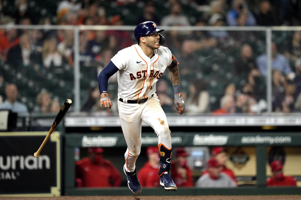 Houston Astros' Carlos Correa tosses his bat after hitting a RBI single against the Los Angeles Angels during the third inning of a baseball game Thursday, April 22, 2021, in Houston. (AP Photo/David J. Phillip)