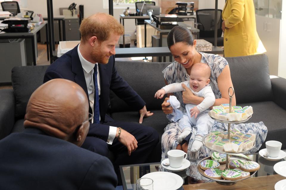 Britain's Duke and Duchess of Sussex, Prince Harry and his wife Meghan hold their baby son Archie as they meet with Archbishop Desmond Tutu at the Tutu Legacy Foundation  in Cape Town on September 25, 2019. - The British royal couple are on a 10-day tour of southern Africa -- their first official visit as a family since their son Archie was born in May. (Photo by HENK KRUGER / POOL / AFP)        (Photo credit should read HENK KRUGER/AFP/Getty Images)