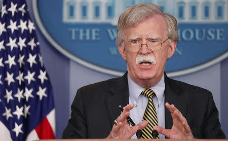 U.S. National Security Advisor John Bolton answers questions from reporters after announcing that the U.S. will withdraw from the Vienna protocol and the 1955 "Treaty of Amity" with Iran as White House Press Secretary Sarah Huckabee Sanders looks on during a news conference in the White House briefing room in Washington, U.S., October 3, 2018. REUTERS/Jonathan Ernst