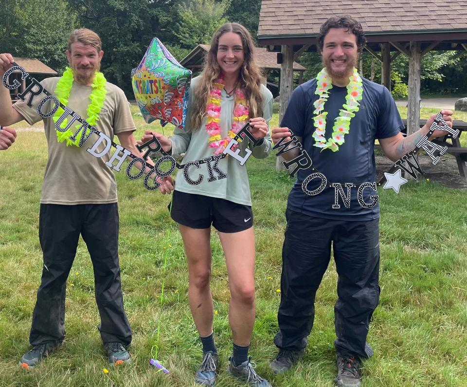 Poughkeepsie native Alexis Holzmann, who completed the 2,200-mile Appalachian Trail in August, poses with party favors while flanked by two of her hiking partners, "Groundhog" and "Wrong Way."