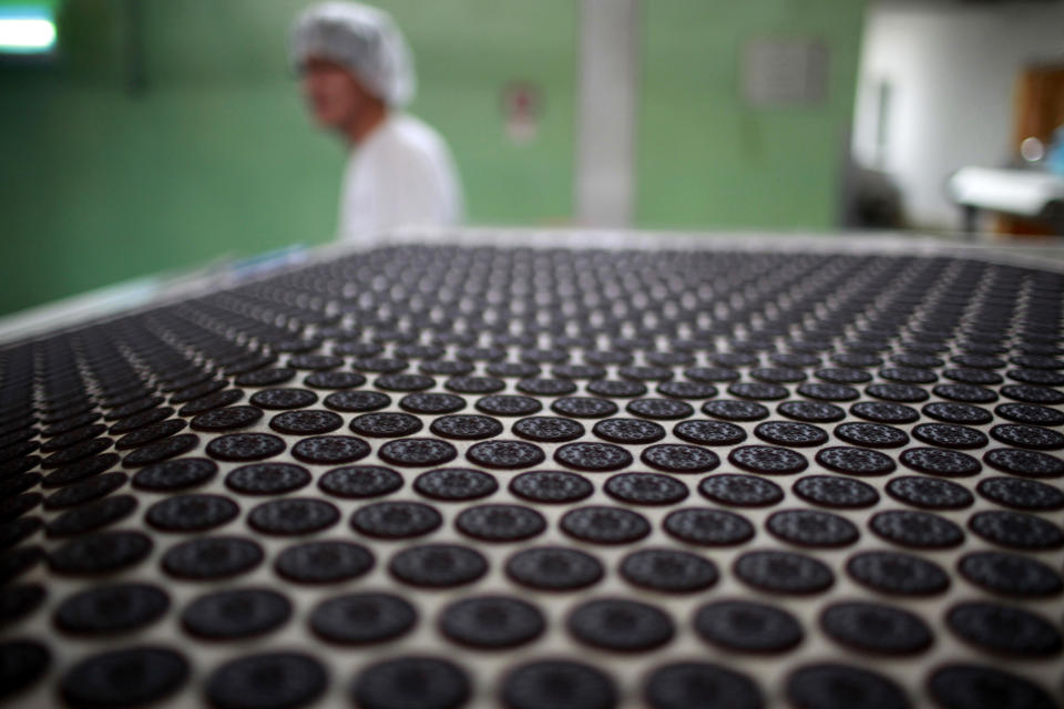 Freshly-baked Oreo cookies pass along a conveyor belt at a Kraft Foods' factory in Suzhou, Jiangsu province, May 30, 2012. Investment may be powering the Chinese economy but experiments like Oreo's gum cookie, a cookie with a glob of gum sandwiched neatly between a pair of Oreo's iconic dark chocolate biscuits instead of the creamy white 