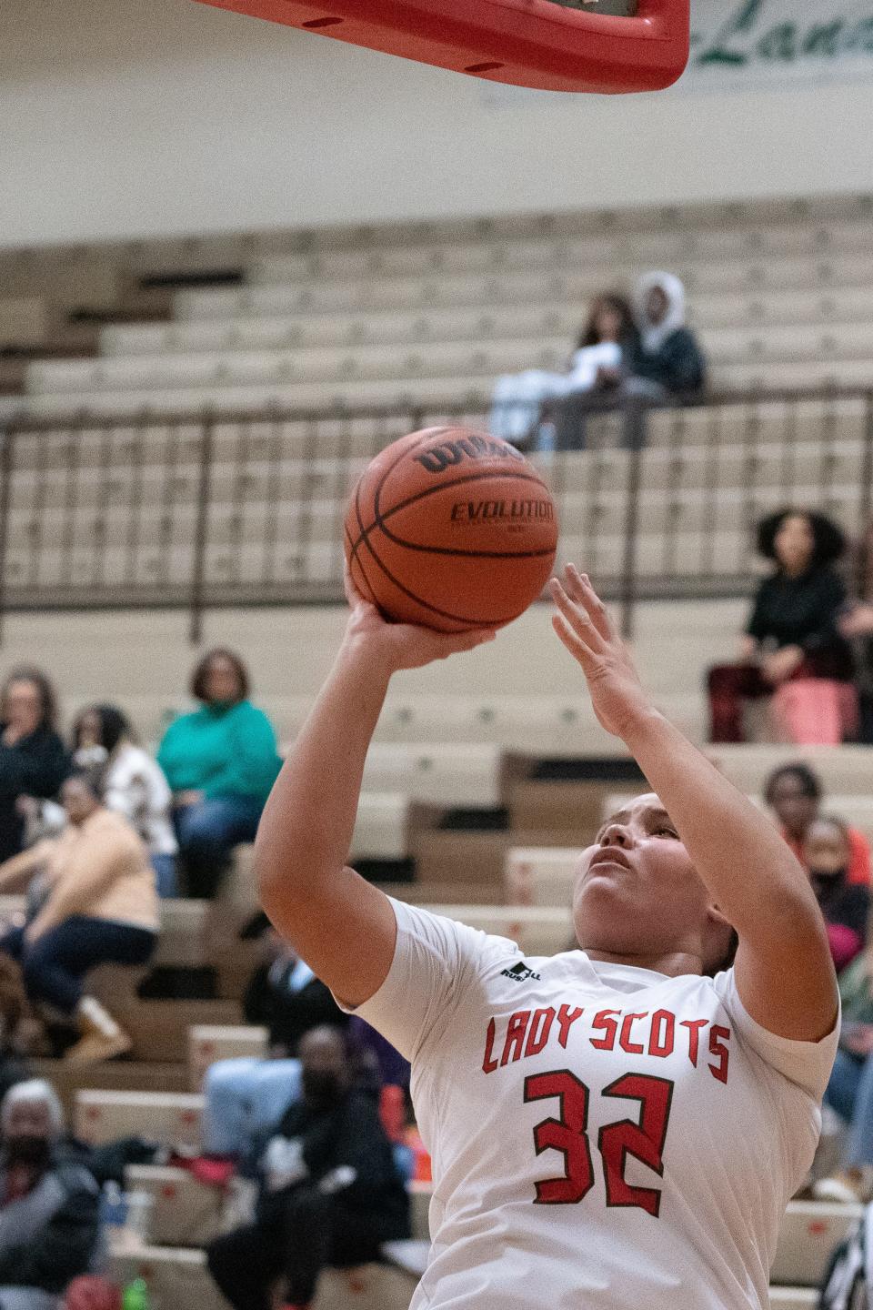 Highland Park sophomore Amelia Ramsey (32) shoots under the basket against Wyandotte.