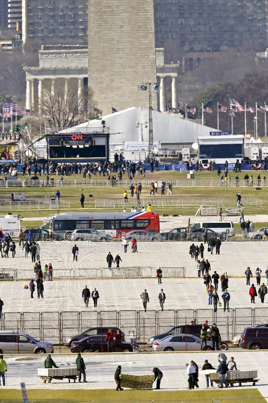 FILE - This Jan. 19, 2013 file photo shows crews laying down special mats to protect the lawn on the National Mall, for the 57th Presidential Inauguration in Washington. White House Press Secretary Sean Spicer incorrectly said Saturday, Jan. 21 that 2017 was “the first time in our nation’s history that floor coverings had been used to protect the grass on the mall.” (AP Photo/J. Scott Applewhite)