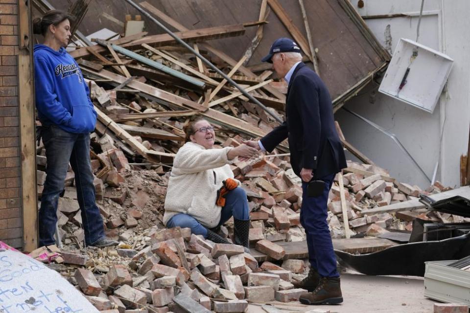 Joe Biden meets with people as he surveys storm damage from tornadoes in Mayfield, Kentucky Wednesday.