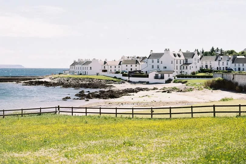 Founded in 1828, Port Charlotte is a village on the island of Islay. A cluster of traditional white houses nestle at the water's edge alongside a small beach with a green meadow in the foreground.

Islay is the southernmost of the Inner Hebrides islands, off the west coast of Scotland.