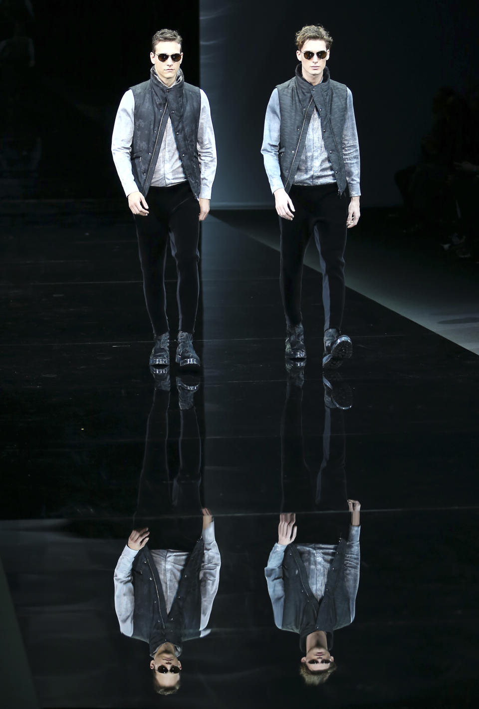 Models wear creations for Emporio Armani men's Fall-Winter 2014 collection, part of the Milan Fashion Week, unveiled in Milan, Italy, Monday, Jan. 13, 2014. (AP Photo/Antonio Calanni)