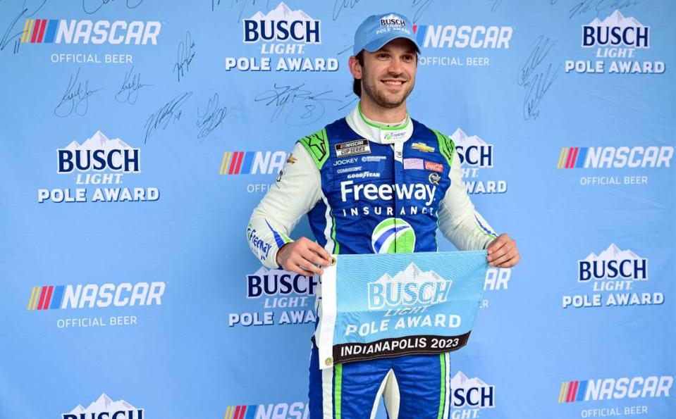 Aug 12, 2023; Speedway, Indiana, USA; Daniel Suarez holds up the pole winners flag after qualifying at the Indianapolis Motor Speedway Road Course.