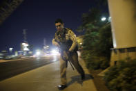 <p>A police officer runs along a sidewalk near a shooting near the Mandalay Bay resort and casino on the Las Vegas Strip, Oct. 1, 2017, in Las Vegas. (Photo: John Locher/AP) </p>