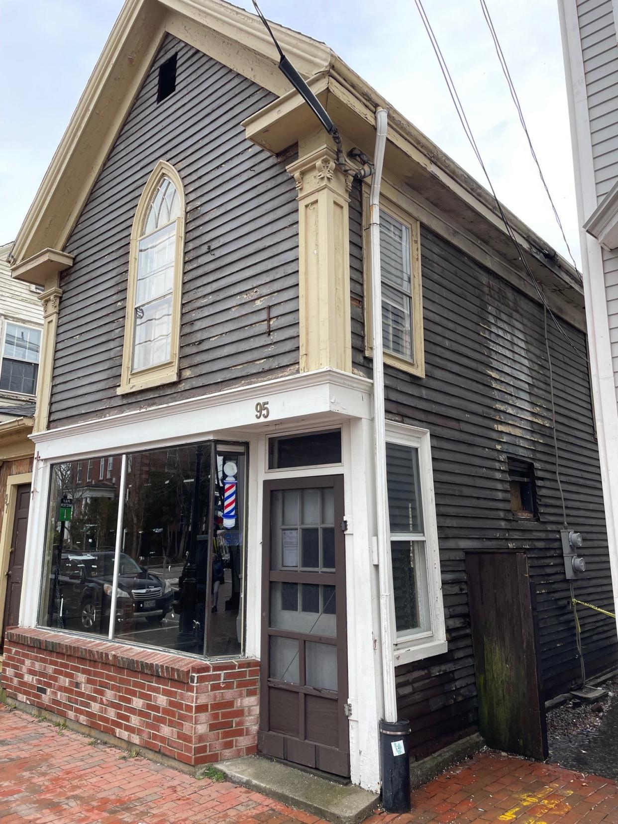 John's Barber Shop was formerly housed at the 95 Daniel St. building in Portsmouth, which the current owner wants to demolish.
