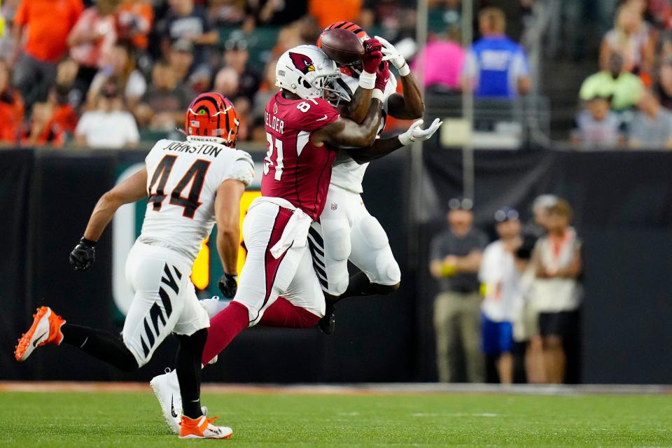 Cincinnati Bengals safety Dax Hill (23) nearly intercepts a pass intended for Arizona Cardinals tight end Deon Yelder (81) in the second quarter of the NFL Preseason Week One game at Paycor Stadium. Mandatory Credit: Sam Greene-USA TODAY Sports