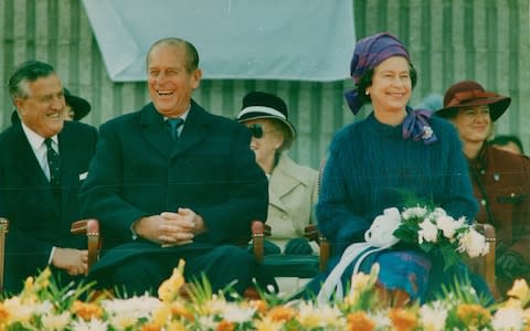 The Queen and Prince Philip enjoy a hearty laugh during their 1984 state visit to Canada, as a flypast drowns out the welcoming speech - Credit:  Erin Combs/Toronto Star via Getty Images