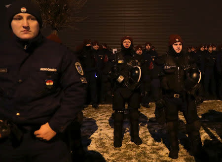 Member of riot police stand outside the headquarters of the Hungarian state television during a protest against a proposed new labor law, billed as the "slave law", in Budapest, Hungary, December 17, 2018. REUTERS/Marko Djurica