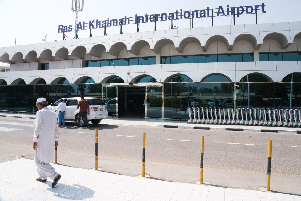 A man walks past the Ras al-Khaimah International Airport in Ras al-Khaimah, United Arab Emirates, Wednesday, Oct. 23, 2019. India's low-cost airline SpiceJet announced plans Wednesday to build its first international hub in the United Arab Emirates, offering a pledge of support to Boeing Co. by saying it would use now-grounded 737 MAX aircraft in the operation once regulators approve the planes for flight. (AP Photo/Jon Gambrell)