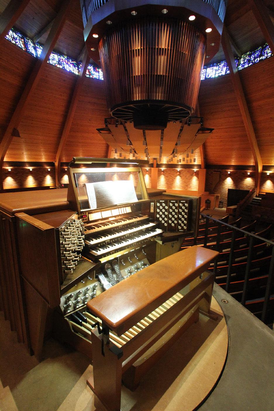 The circular pipe organ is shown at the Agnes Flanagan Chapel Tuesday, June 12, 2012, on the campus of Lewis & Clark College, in Portland, Ore. The Agnes Flanagan Chapel is a 16-sided architectural marvel that seats 650 under stained glass windows depicting the book of Genesis. In the early 1970s, it was also a big, conical quandary. Chapels aren’t really chapels unless they have an organ, and the newly-minted structure at Portland’s Lewis & Clark College was in need. (AP Photo/Rick Bowmer)