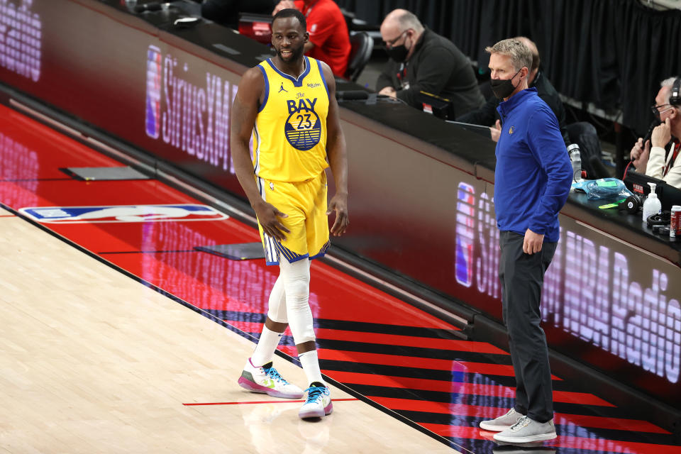 PORTLAND, OREGON - MARCH 03: Draymond Green #23 and head coach Steve Kerr of the Golden State Warriors have a conversation in the second quarter against the Portland Trail Blazers at Moda Center on March 03, 2021 in Portland, Oregon. NOTE TO USER: User expressly acknowledges and agrees that, by downloading and or using this photograph, User is consenting to the terms and conditions of the Getty Images License Agreement. (Photo by Abbie Parr/Getty Images)