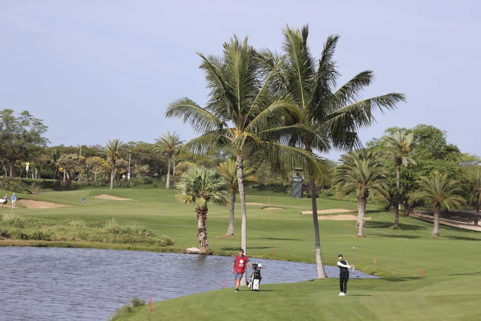 Hinako Shinobu, of Japan, watche her shot from the 11th fairway during the first round of the LPGA golf tournament Wednesday, April 12, 2023, near Honolulu. (AP Photo/Marco Garcia)